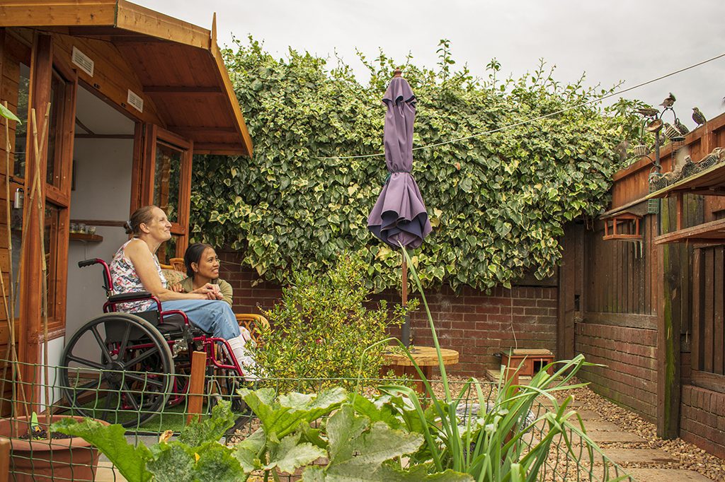 Authentic Disabled Female in Wheelchair With Asian Caregiver, Carer, Real, Healthcare.